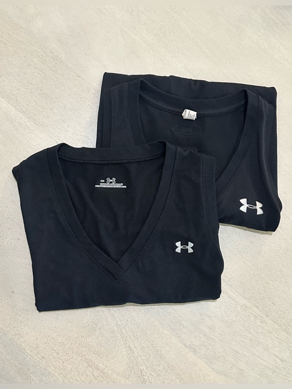 Under Armour. TWO Black Athletic Sleeveless Tee with Logo.